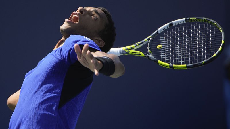 Felix Auger-Aliassime, of Canada, returns a shot to Jakub Mensik, of the Czech Republic, during the first round of the U.S. Open tennis championships, Tuesday, Aug. 27, 2024, in New York. (AP Photo/Pamela Smith)