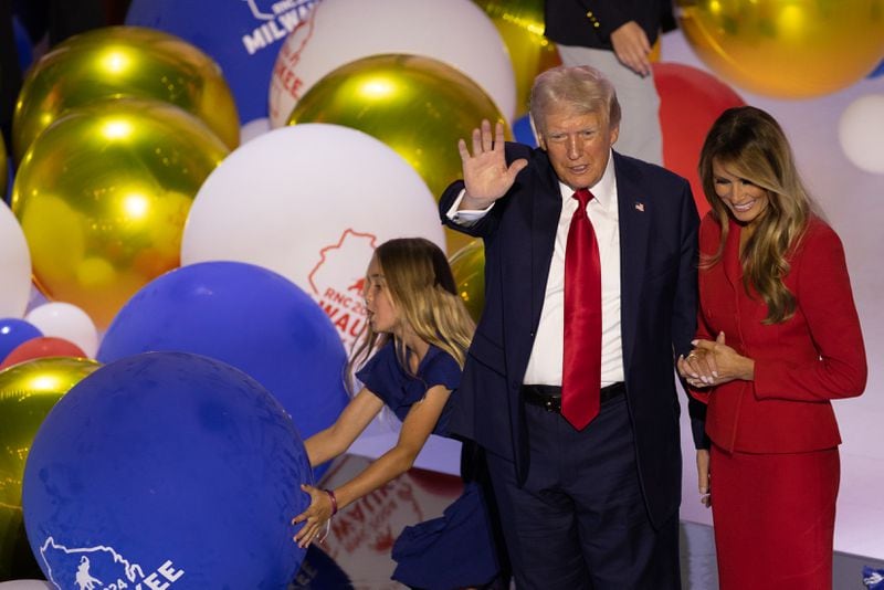 Former President Donald Trump, with his wife Melania beside him, waves as balloons drop at the Republican National Convention in Milwaukee.