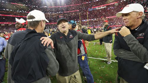 Georgia head coach Kirby Smart, center, celebrates with assistant coaches Mike Bobo, left, and Todd Monken after their win against TCU in the 2023 College Football Playoff National Championship at SoFi Stadium, Monday, Jan. 9, 2023, in Inglewood, Ca. Georgia won 65-7. (Jason Getz / Jason.Getz@ajc.com)