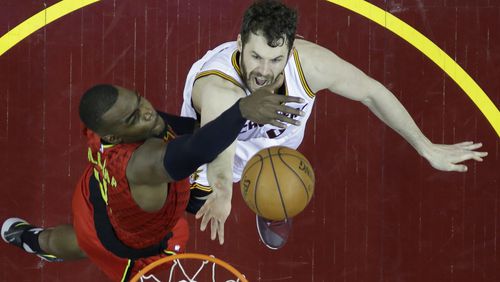 Cleveland Cavaliers' Kevin Love (0) shoots against Atlanta Hawks' Paul Millsap (4) in the second half in Game 1 of a second-round NBA basketball playoff series, Monday, May 2, 2016, in Cleveland. The Cavaliers won 104-93. (AP Photo/Tony Dejak)