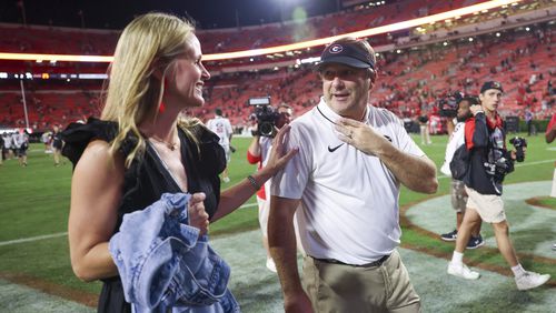 Georgia head coach Kirby Smart and his wife Mary Beth talk as they walk off of the field following Georgia’s win against UAB at Sanford Stadium, Saturday, September 23, 2023, in Athens, Ga. Georgia won 49-21. (Jason Getz / Jason.Getz@ajc.com)