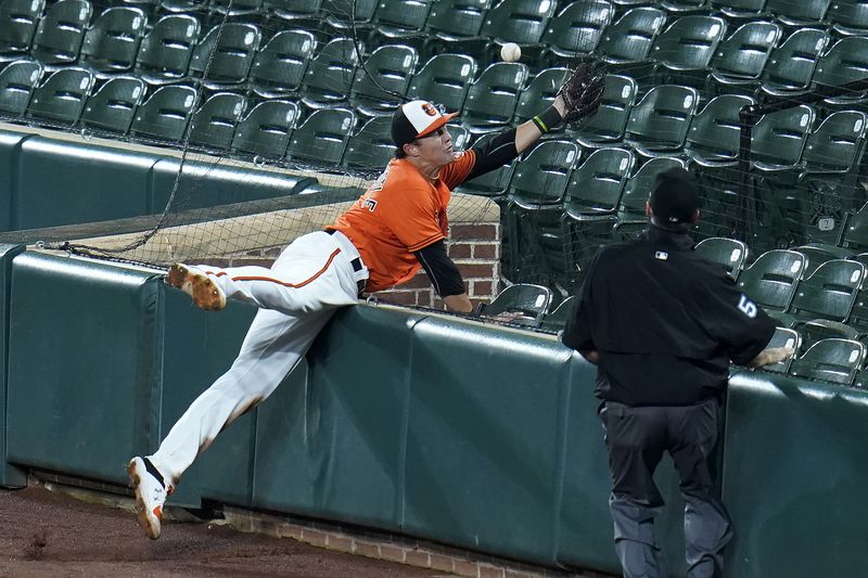 FILE - Baltimore Orioles first baseman Ryan Mountcastle reaches into the empty stands but is unable to catch a foul ball by Tampa Bay Rays' Joey Wendle during the fifth inning of the second baseball game of a doubleheader, Thursday, Sept. 17, 2020, in Baltimore. (AP Photo/Julio Cortez, File)