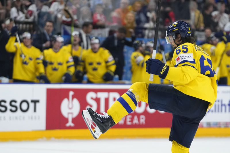 Sweden's Erik Karlsson celebrates after scoring his sides second goal during the bronze medal match between Sweden and Canada at the Ice Hockey World Championships in Prague, Czech Republic, Sunday, May 26, 2024. (AP Photo/Petr David Josek)