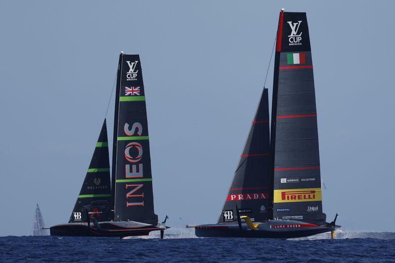 INEOS Britannia, left, and Luna Rosa Prada Pirelli sailing teams compete during the Louis Vuitton Cup Final Day 7 at the Barcelona's coast, Spain, Friday, Oct. 4, 2024. (AP Photo/Joan Monfort)