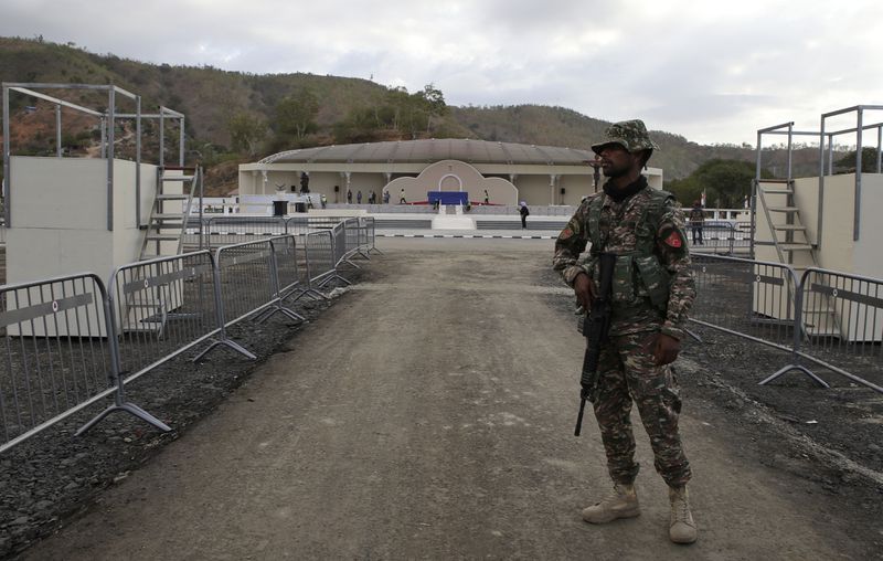 A security officer stands guard in Tasitolu, an open field on the coast which will be the venue of a papal Mass, in Dili, East Timor, Thursday, Sept. 5, 2024. (AP Photo/Firdia Lisnawati)