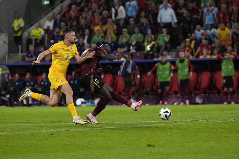 Belgium's Romelu Lukaku, right, scores his side's second goal during a Group E match between Belgium and Romania at the Euro 2024 soccer tournament in Cologne, Germany, Saturday, June 22, 2024. The goal was later disallowed after a VAR review. (AP Photo/Alessandra Tarantino)