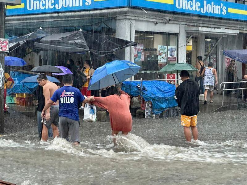 A typhoon kills 3 as it nears Taiwan. It killed 13 in the Philippines,  where people plead for rescue