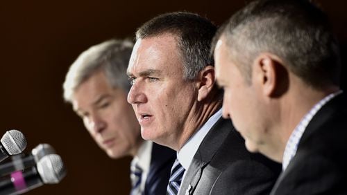 Shawn Elliott, center, speaks at a news conference where he was introduced as the head football coach for Georgia State in Atlanta, Georgia, on Friday, December 9, 2016. He was joined by Georgia State president, Mark Becker, left, and athletic director Charlie Cobb, right. (DAVID BARNES / DAVID.BARNES@AJC.COM)
