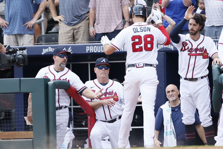 Atlanta Braves first baseman Matt Olson enters the dugout after hitting a solo home run during the eighth inning Sunday at Truist Park. (Miguel Martinez / miguel.martinezjimenez@ajc.com)