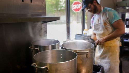 Line cook William Miracle works in the kitchen next to large pots that are boiling water on June 3 at Sun in my Belly in the Kirkwood neighborhood of Atlanta. (Jason Getz/The Atlanta Journal-Constitution)