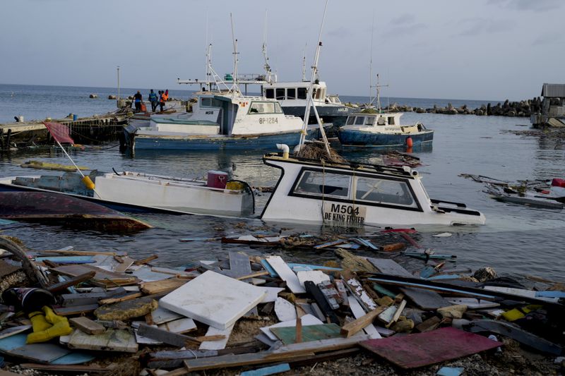 Boats damaged by Hurricane Beryl wade in the water at the Bridgetown Fisheries, Barbados, Tuesday, July 2, 2024. (AP Photo/Ricardo Mazalan)