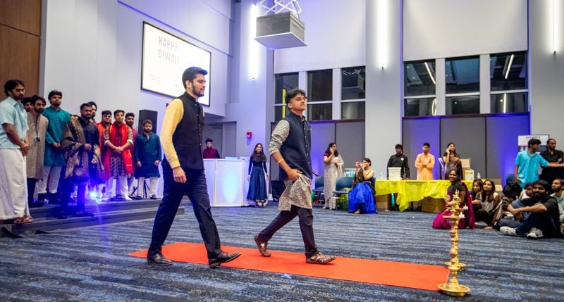 Vishrut Thaker (front, center), the president of MannMukti, a student organization that focuses on mental health education, outreach and awareness at Georgia State University, speaks before a Diwali fashion show on Wednesday, Nov. 15, 2023. (Jenni Girtman for The Atlanta Journal-Constitution)