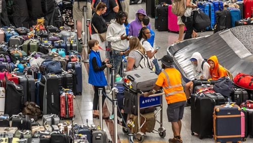 Baggage stored in the Delta Air Lines baggage claim area wait for passengers to claim them on Tuesday, July 23, 2024, amid the disruption caused by a global technology outage that upended the Atlanta-based carrier. (John Spink/AJC)