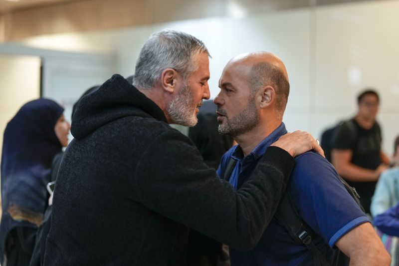 Lebanese citizen Ali Zeineddine, left, greets his brother Hussein arriving from Lebanon, after an Israeli air strike killed various members of their family, at Sao Paulo International airport, Thursday, Oct. 3, 2024. (AP Photo/Andre Penner)