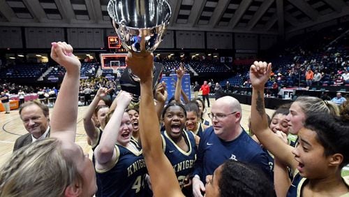 River Ridge players celebrate their win over Lovejoy Friday in the Class 6A girls state championship game in Macon.