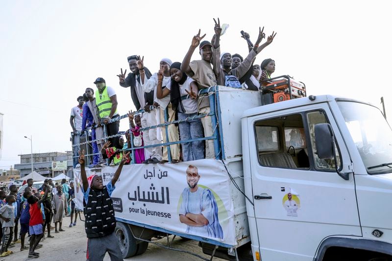 Youth take part in an electoral rally ahead of the upcoming presidential elections in Nouakchott, Mauritania, Tuesday, June 25, 2024. Banner in Arabic reads "For the youth." (AP Photo/Mamsy Elkeihel)
