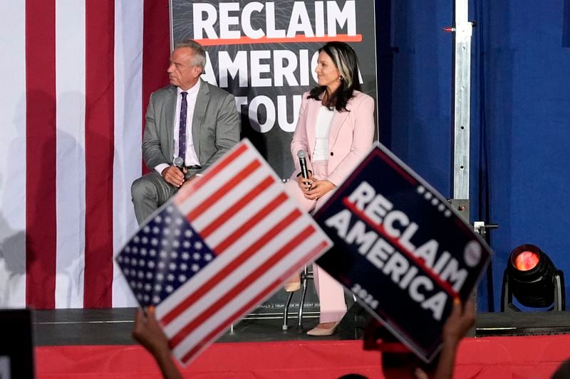 Former Independent candidate for president Robert F. Kennedy, Jr., left, and former Democratic Rep. Tulsi Gabbard listen to a question at a campaign event for Republican presidential nominee former President Donald Trump, Saturday, Sept. 14, 2024, in Glendale, Ariz. (AP Photo/Ross D. Franklin)