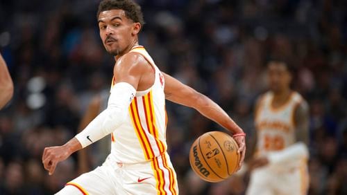 Hawks guard Trae Young fakes a behind-the-back pass during the first quarter against the host Kings on Wednesday night. (AP Photo/José Luis Villegas)