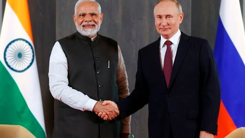 FILE -Russian President Vladimir Putin, right, and Indian Prime Minister Narendra Modi pose for a photo shaking hands prior to their talks on the sidelines of the Shanghai Cooperation Organisation (SCO) summit in Samarkand, Uzbekistan, Sept. 16, 2022. The Kremlin on Thursday said Modi will visit Russia on July 8-9 and hold talks with Putin. The visit was first announced by the Russian officials last month, but the dates have not been previously disclosed. (Alexandr Demyanchuk, Sputnik, Kremlin Pool Photo via AP, File)