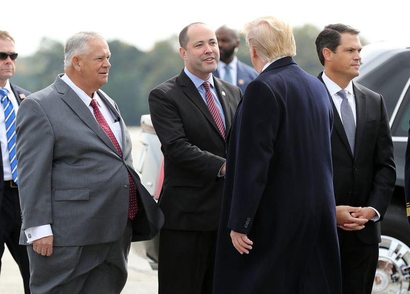 Georgia House Speaker David Ralston (left), Attorney General Chris Carr (center), and Lieutenant Governor Geoff Duncan (right) greet President Donald Trump after he arrived at Dobbins Air Reserve Base on Nov. 8, 2019. Curtis Compton/ccompton@ajc.com