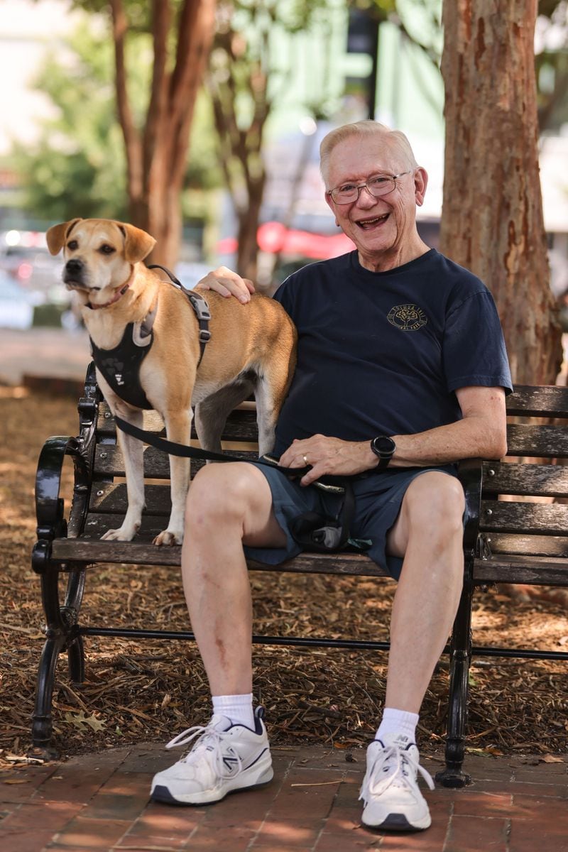 Tom Bonnar, 76, of Marietta, poses for a photo with his dog Sophie at Marietta Square on Monday, July 15, 2024. (Natrice Miller/ AJC)
