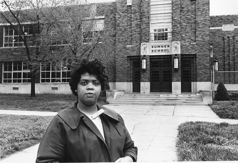     This May 8, 1964 file photo shows Linda Brown Smith standing in front of the Sumner School in Topeka, Kansas.  The landmark Brown v. Board of Education decision was handed down 70 years ago this week.