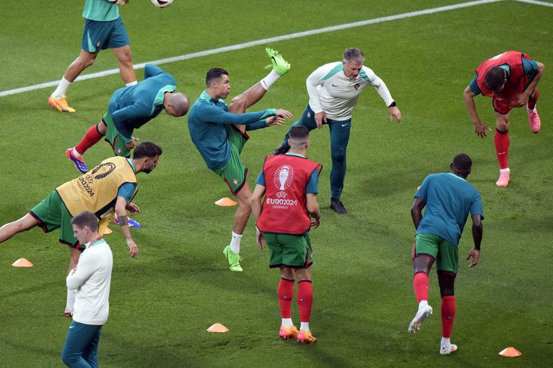 Portugal's Cristiano Ronaldo, center left, warms up before a Group F match between Portugal and Czech Republic at the Euro 2024 soccer tournament in Leipzig, Germany, Tuesday, June 18, 2024. (AP Photo/Sergei Grits)