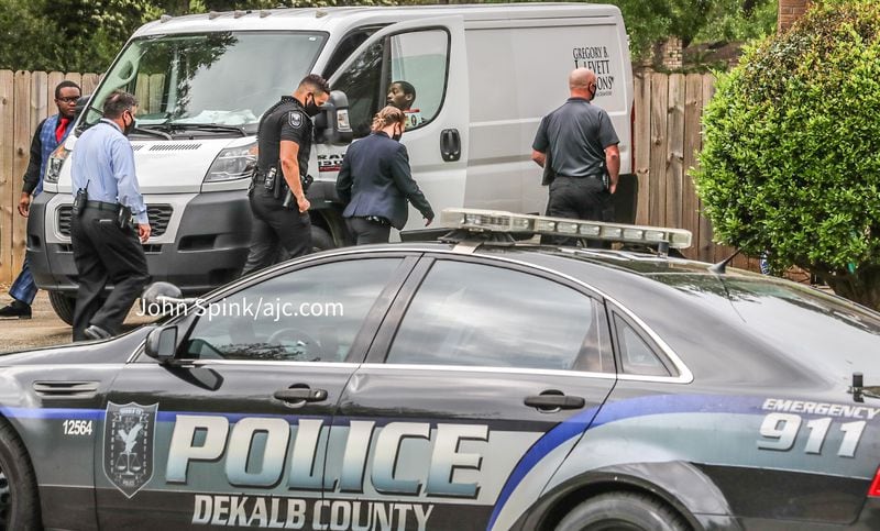 A funeral home van arrived shortly before 10:30 a.m. to collect a body.