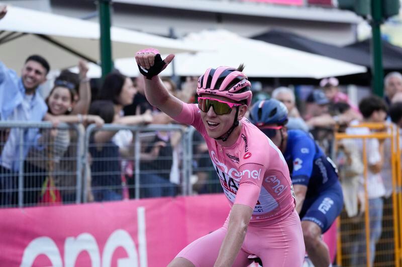 Slovenia's Tadej Pogacar, wearing the pink jersey overall leader, crosses the finish line of the 21st and last stage of the Giro D'Italia, tour of Italy cycling race, in Rome, Sunday, May 26, 2024. (AP Photo/Andrew Medichini)