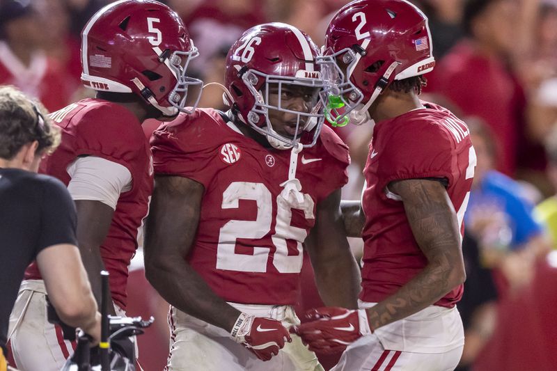 Alabama running back Jam Miller (26) celebrates his touchdown with Alabama wide receiver Ryan Williams (2) during the second half of an NCAA college football game against South Florida, Saturday, Sept. 7, 2024, in Tuscaloosa, Ala. Alabama wide receiver Germie Bernard (5) is also pictured. (AP Photo/Vasha Hunt)