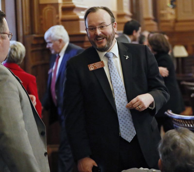 FILE - Rep. Scot Turner, R - Holly Springs, confers with colleagues on the floor of the Georgia State House in Atlanta, Feb. 8, 2018. (Bob Andres/Atlanta Journal-Constitution via AP, File)