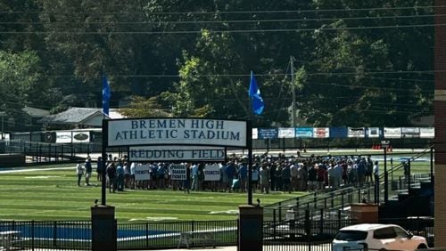 Community members gather on the football field at Bremen High School to pray for Carson Kimball, who was injured in a football game Friday night.