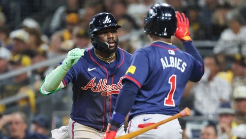 Atlanta Braves’ Michael Harris is greeted by Ozzie Albies (1) after a 2-RBI home run against the San Diego Padres during the eighth inning of National League Division Series Wild Card Game Two at Petco Park in San Diego on Wednesday, Oct. 2, 2024.   (Jason Getz / Jason.Getz@ajc.com)