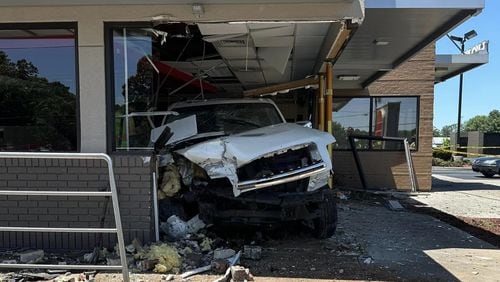 Lawrenceville police plan to file reckless driving charges, among others, against the driver of a white SUV that crashed into a Burger King on Grayson Highway.