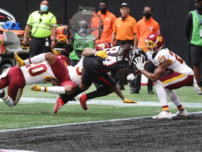 Falcons running back Cordarrelle Patterson bulls his way the final yards into the end zone through three Washington Football Team defenders during the final minute of the second quarter Sunday, Oct. 3, 2021, in Atlanta. (Curtis Compton / Curtis.Compton@ajc.com)