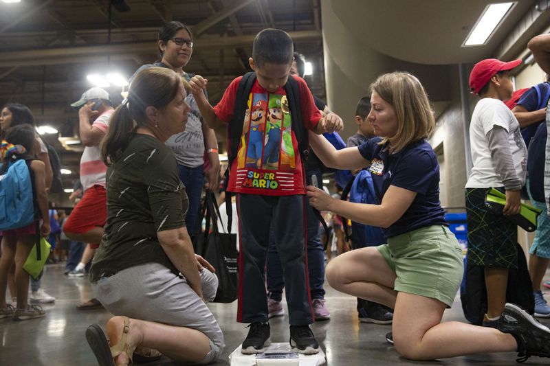 Jonathan Velazquez, 6, gets his backpack fitted by occupational therapist Kathy Espinosa, left, and occupational therapy student Tracy Selner during the 13th Annual Back to School Bash and Safety Fair at the Palmer Events Center on Saturday, Aug. 4, 2018. Almost 150 community organizations and Austin school district departments provided information and activities to prepare students for a safe and successful school year. LYNDA M. GONZALEZ / AMERICAN-STATESMAN