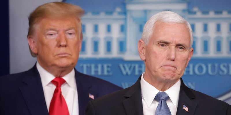 President Donald Trump, left, listens to Vice President Mike Pence, right, as he pauses while speaking to members of the media to address the nation about the coronavirus threat.