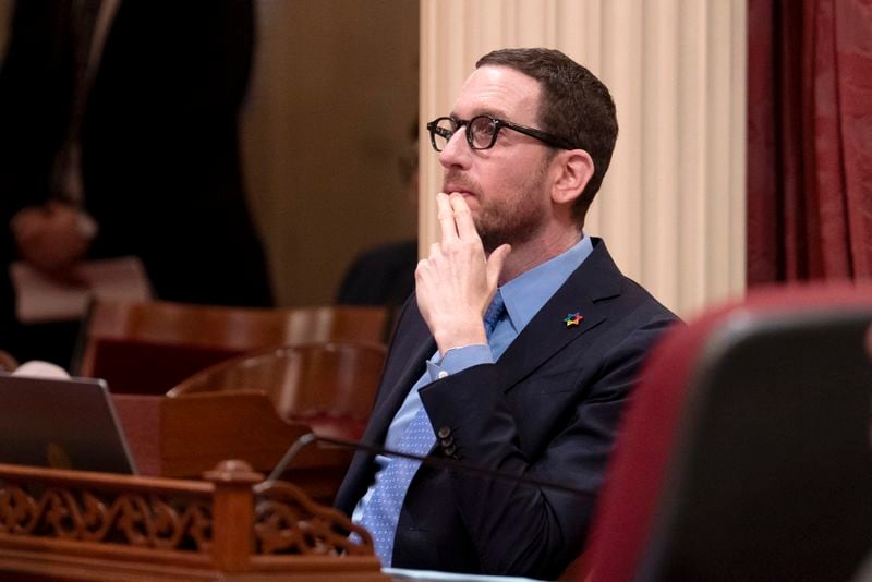 FILE - State Sen. Scott Wiener, D-San Francisco, watches as the Senate votes on a measure at the Capitol in Sacramento, Calif., Thursday, April 11, 2024. Wiener is the author of a bill aiming to regulate powerful generative AI systems.Tech giants including Meta and Google are joining small tech startups in California to push back on the bill, they argue the proposal would stifle innovation in a state that is touting itself as a global AI hub. (AP Photo/Rich Pedroncelli,File)