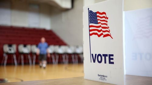 In this file photo, a voter walks away from the voting booths at Henry W. Grady High School in Atlanta on July 24, 2018. (JASON GETZ/SPECIAL TO THE AJC)