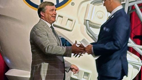 Georgia head coach Kirby Smart, left, and Southeastern Conference commissioner Greg Sankey shake hands at SEC NCAA college football media days in Dallas Tuesday, July 16, 2024. (Hunter Dawkins/The Gazebo Gazette via AP)