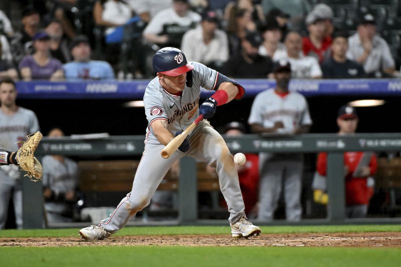 Washington Nationals' Jacob Young singles on a bunt against the Colorado Rockies during the seventh inning of a baseball game Saturday, June 22, 2024, in Denver. (AP Photo/Geneva Heffernan)
