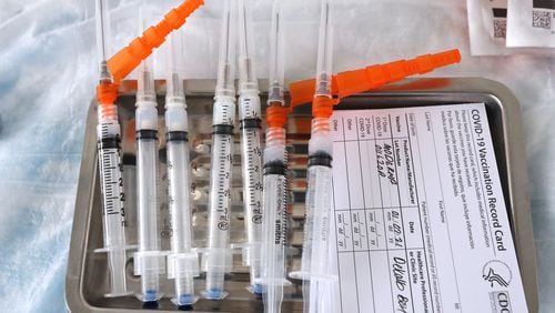 010721 DORAVILLE: Moderna COVID-19 vaccines sit on a tray as they are prepared to be administered to health care workers at the DeKalb COVID-19 BrandsMart USA drive through testing site on Thursday, Jan. 7, 2021, in Doraville.   Curtis Compton / Atlanta Journal-Constitution.