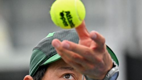 Kei Nishikori serves the ball against Taylor Fritz during a quarterfinal match at the 2023 Atlanta Tennis Open at Atlantic Station, Friday, July 28, 2023, in Atlanta. (Hyosub Shin / Hyosub.Shin@ajc.com)