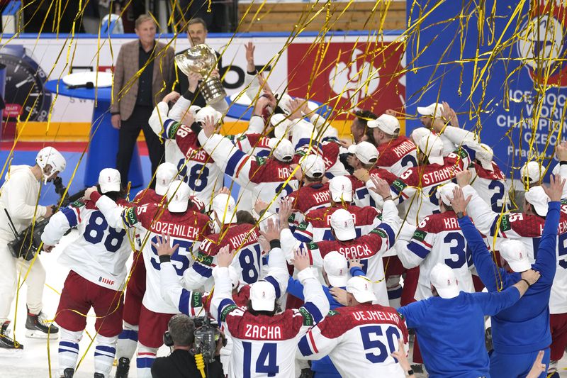 Members of the Czech Republic team celebrate with their trophy after they defeated Switzerland 2-0 in a gold medal match at the Ice Hockey World Championships in Prague, Czech Republic, Sunday, May 26, 2024. (AP Photo/Darko Vojinovic)