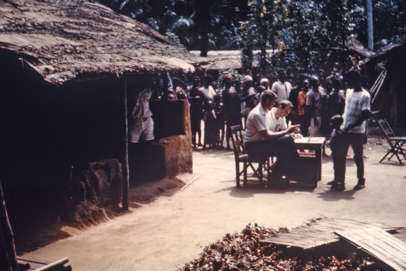 In 1968, Dr. William Foege of the CDC, seated closest to the camera, is shown issuing ration cards to the needy in Port Harcourt, Nigeria. The CDC was asked in 1967 to assist the International Committee of the Red Cross (ICRC) in disease control and death prevention at numerous relief camps outside of the warzone.

