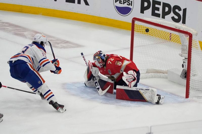 Edmonton Oilers center Mattias Janmark (13) scores against Florida Panthers goaltender Sergei Bobrovsky (72) during the first period of Game 7 of the NHL hockey Stanley Cup Final, Monday, June 24, 2024, in Sunrise, Fla. (AP Photo/Rebecca Blackwell)