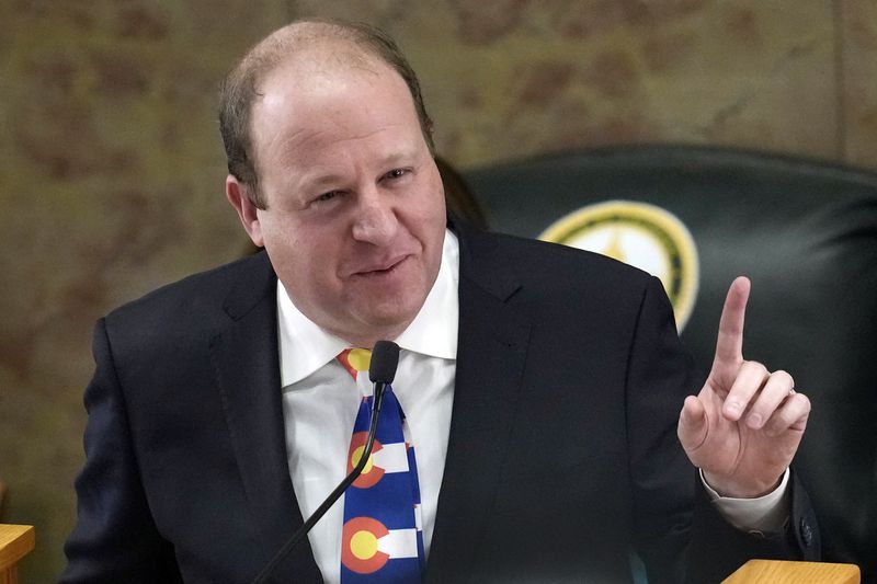 FILE - Colorado Gov. Jared Polis in the House of Representatives chamber in the State Capitol, Jan. 17, 2023, in Denver. State lawmakers’ first attempts at curtailing discrimination in artificial intelligence programs that play a hidden role American's lives are floundering across the country. Only Colorado's bill has been signed by the governor Polis. (AP Photo/David Zalubowski, File)