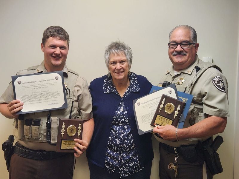 Deputy Wesley Birjkovff (left) and Deputy Carlos Ortiz received awards for helping save Debbie Ruch from her sinking car.
