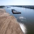 FILE - Barges float in the Mississippi River as a portion of the riverbed is exposed, on Sept. 15, 2023, in St. Louis. The U.N. weather agency is reporting that 2023 was the driest year in more than three decades for the world's rivers, as the record-hot year underpinned a drying up of water flows and contributed to prolonged droughts in some places. (AP Photo/Jeff Roberson, File)