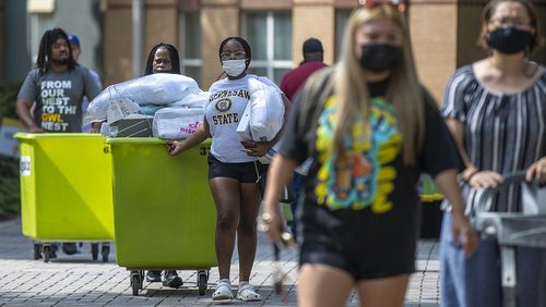 Kennesaw State University student Janay Bennett, third from left, and her mother Felicia Robinson move her belongings to her new dorm during move-in day at Kennesaw State University Campus in Kennesaw, Thursday, August 12, 2021. Kennesaw State was one of the few public colleges in the state that saw an enrollment increase this fall. Overall, 21 of 26 University System of Georgia schools saw enrollment drop this semester, similar to national trends. (Alyssa Pointer/Atlanta Journal Constitution)